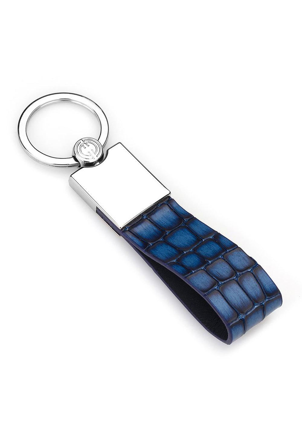 A cool color of indigo blue stamped in soft leather makes for a good gift for yourself or someone else.  Soft leather fashion stamped. Chrome accent key holder. Approximately 3" by 1/2"  By Marcello Sport