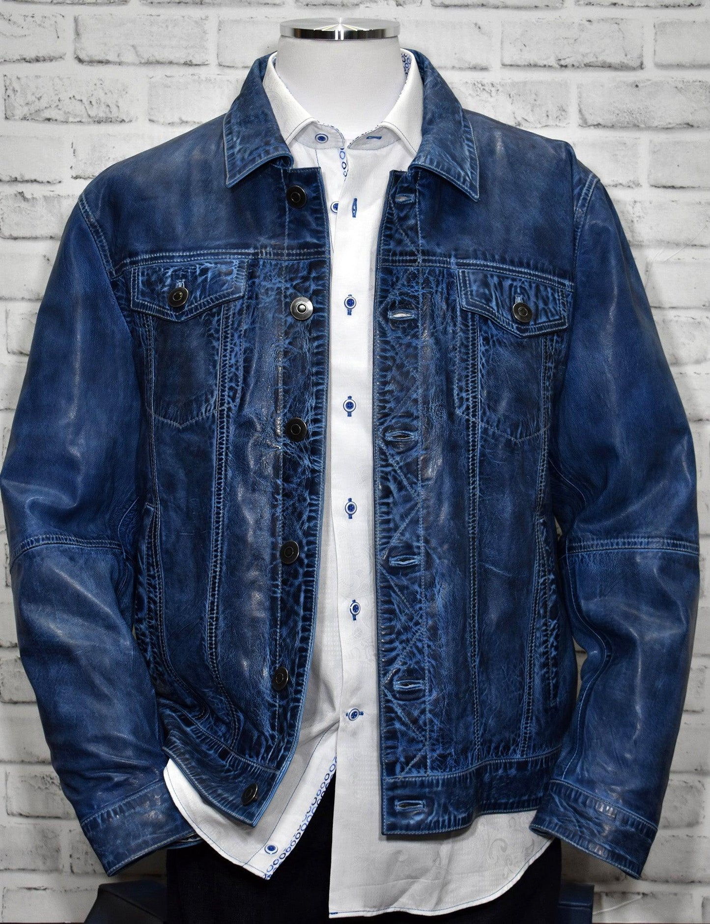 A new twist on an oldie but goodie.  The classic denim coat has always been in style and now it is available in a soft washed leather finish.  Make a fashion statement in something other than your regular leather bomber.  Blue denim leather by Marcello Sport