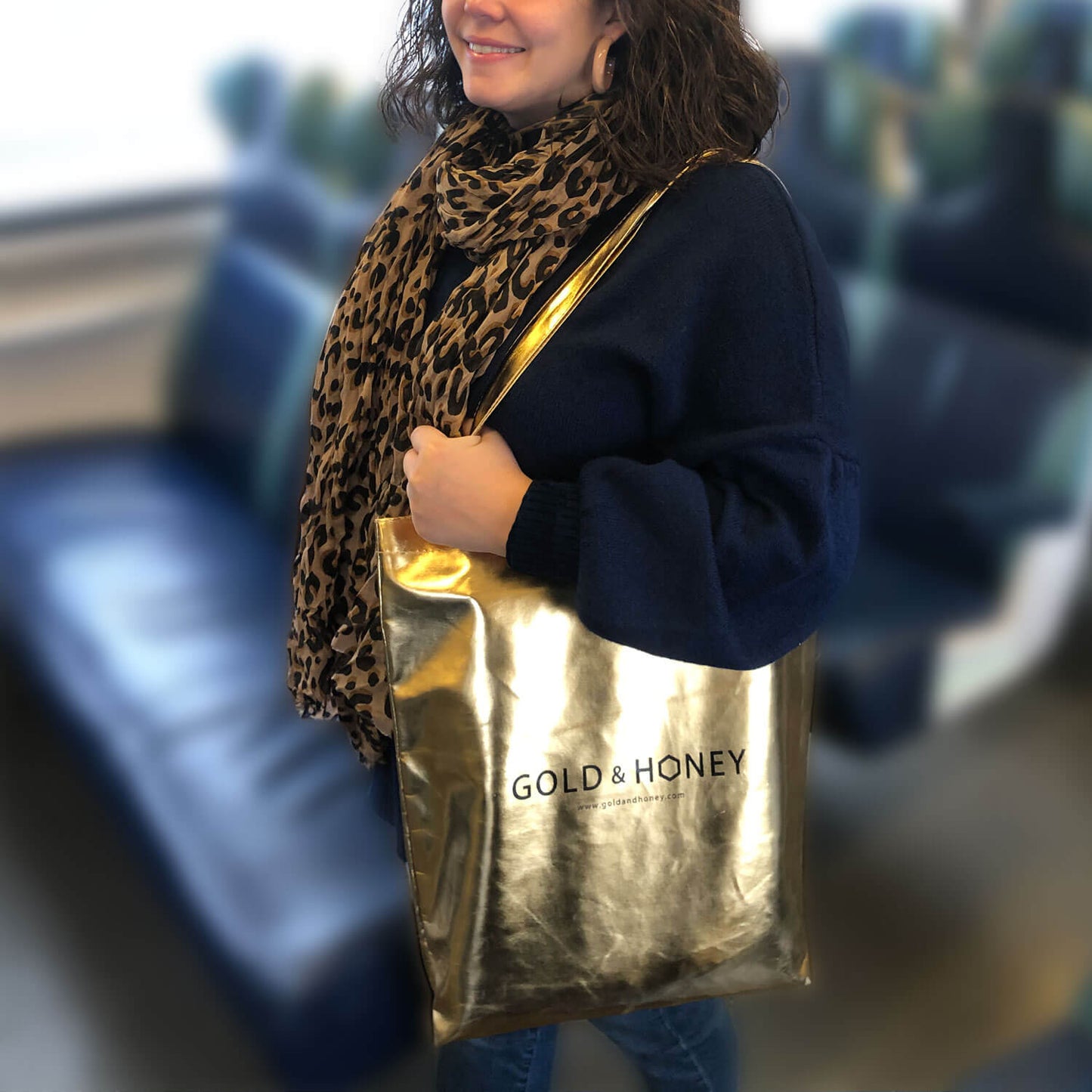Gold tote bag on shoulder
